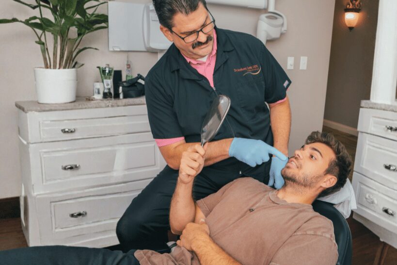 Dr. Lordo talking with patient about All-On-4 dental implants at dental office.